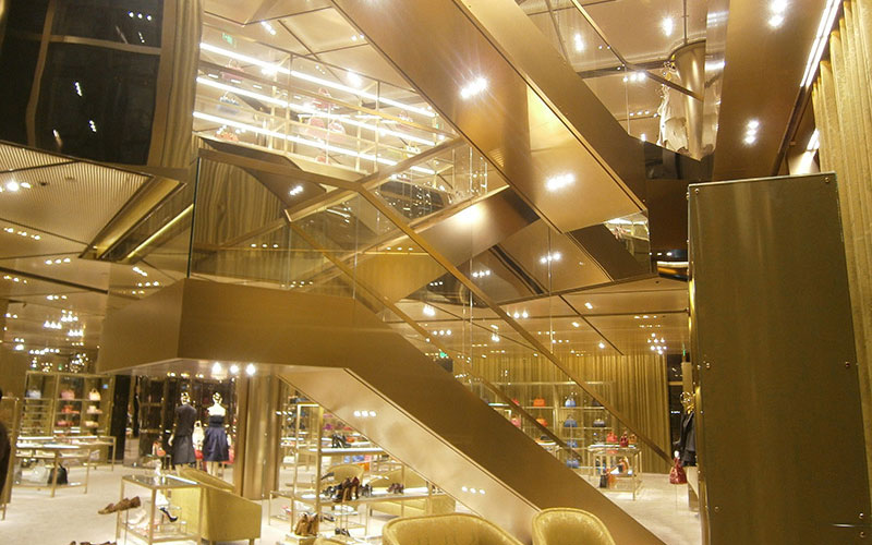Miu Miu-achieving a uniform retail exterior and interior in gold stainless steel